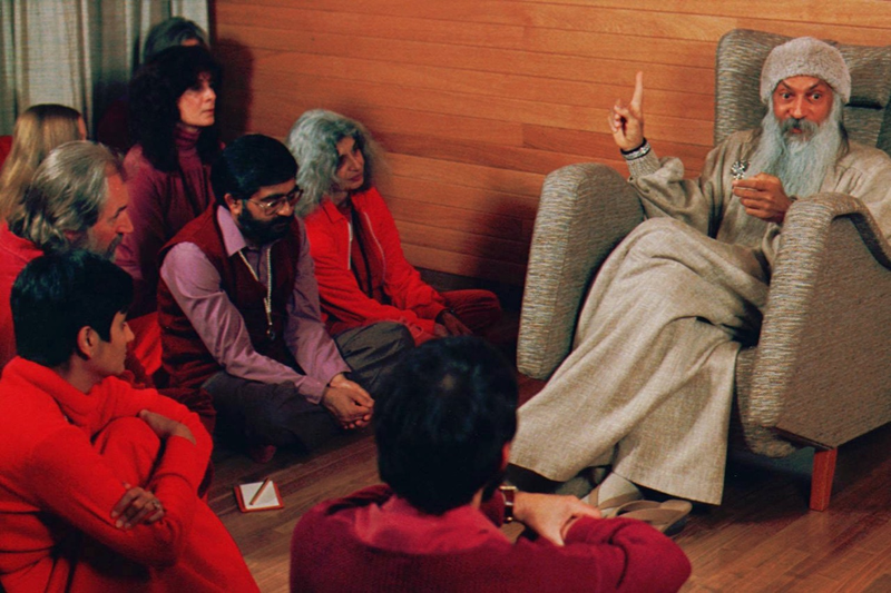 Bhagwan Shree Rajneesh (right) speaks to his followers in Oregon in the early 1980s (AP Photo/Jack Smith)